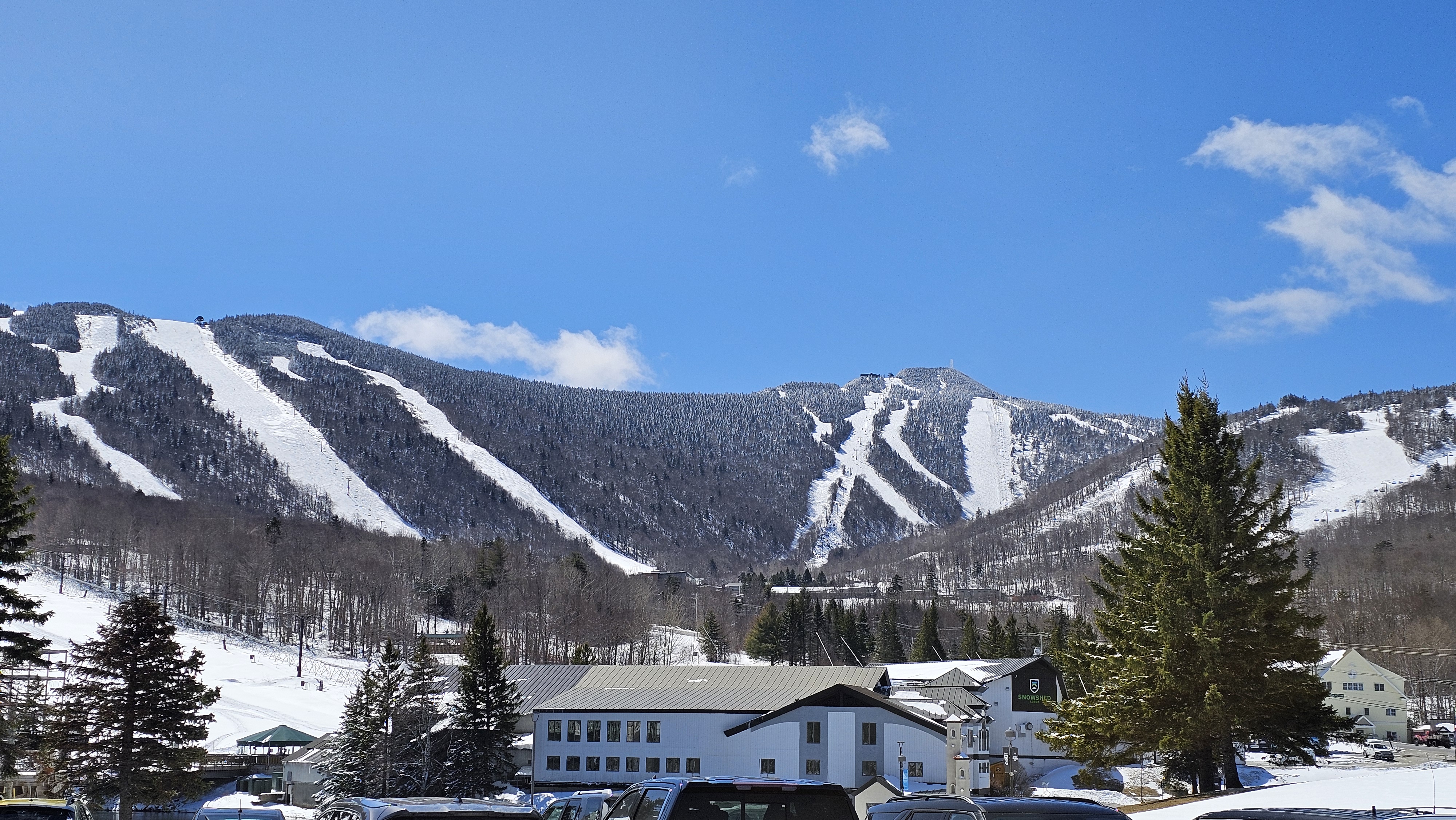 The snow-covered mountains on the day of the conference with clear blue skies. with a clea